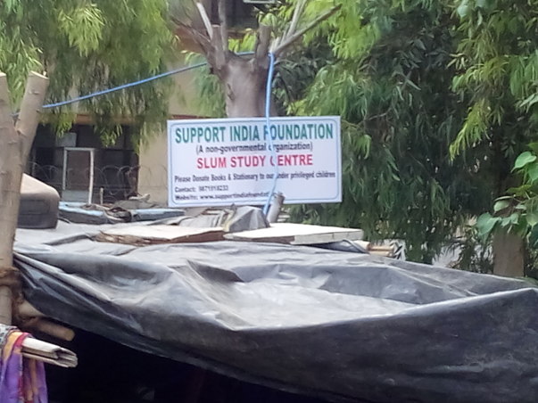 Board of Support India at Keshavpuram railway slum