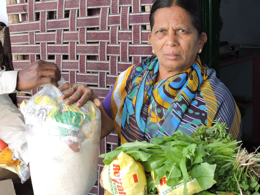 Elderly person in AndhraPradesh getting food support from NGO