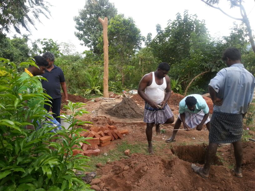 Digging the ground to place the metal pillars Digging the ground to place the metal pillars
